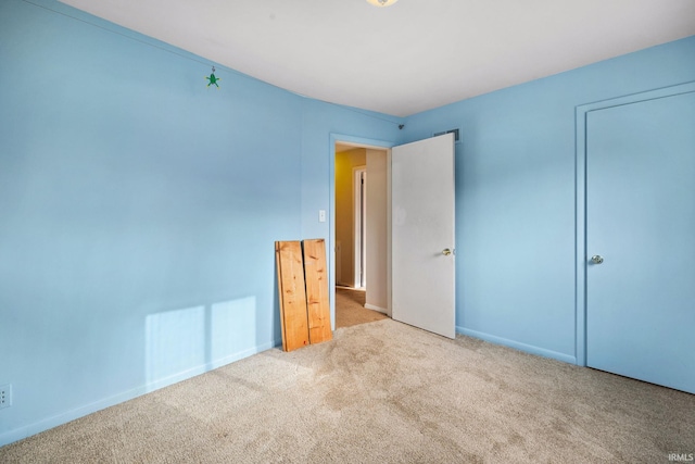 unfurnished bedroom with light colored carpet