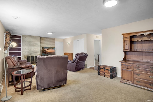 living room with light carpet, a textured ceiling, and a brick fireplace