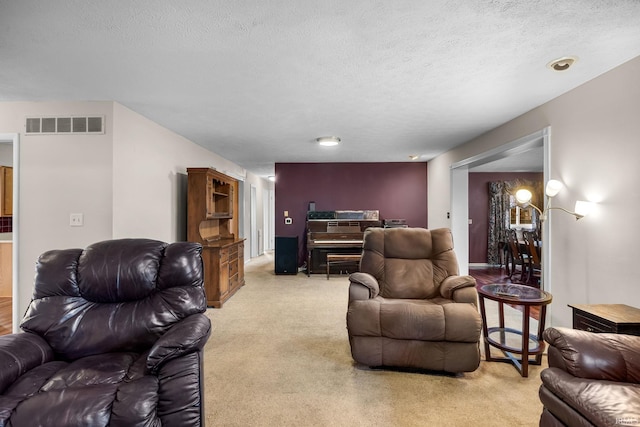 living room with a textured ceiling and light carpet