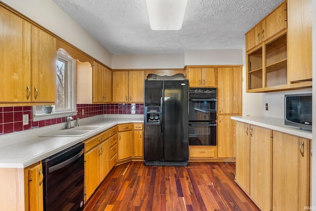 kitchen featuring black appliances, backsplash, dark hardwood / wood-style flooring, and sink