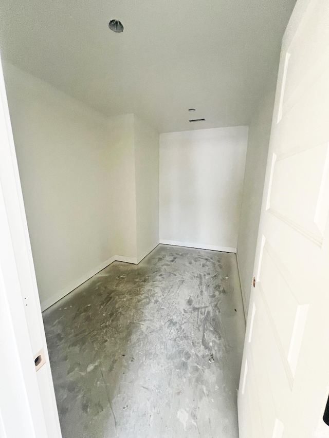 unfurnished room featuring concrete flooring