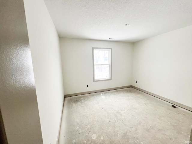 spare room with a textured ceiling