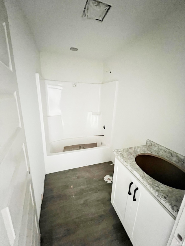 bathroom featuring vanity, hardwood / wood-style flooring, and shower / bathing tub combination