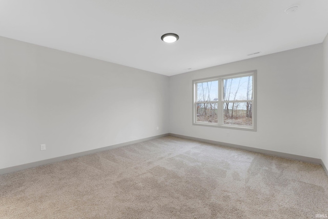 spare room with light colored carpet