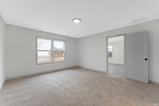 carpeted empty room featuring plenty of natural light