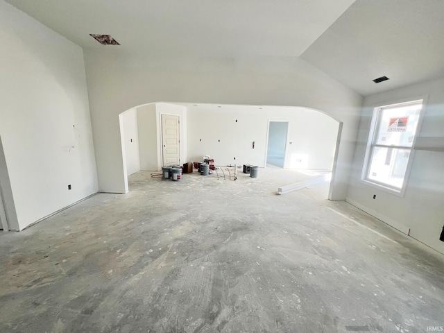 unfurnished living room featuring high vaulted ceiling