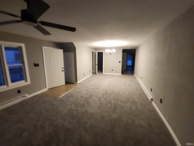 empty room with carpet and ceiling fan with notable chandelier