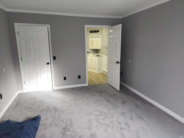 unfurnished bedroom featuring light colored carpet and ornamental molding