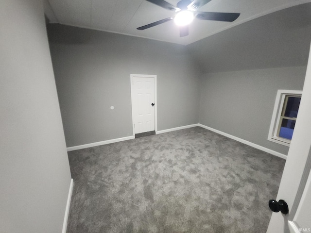 bonus room featuring ceiling fan and dark carpet