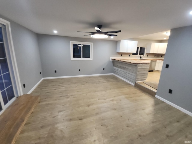 interior space featuring ceiling fan and light wood-type flooring