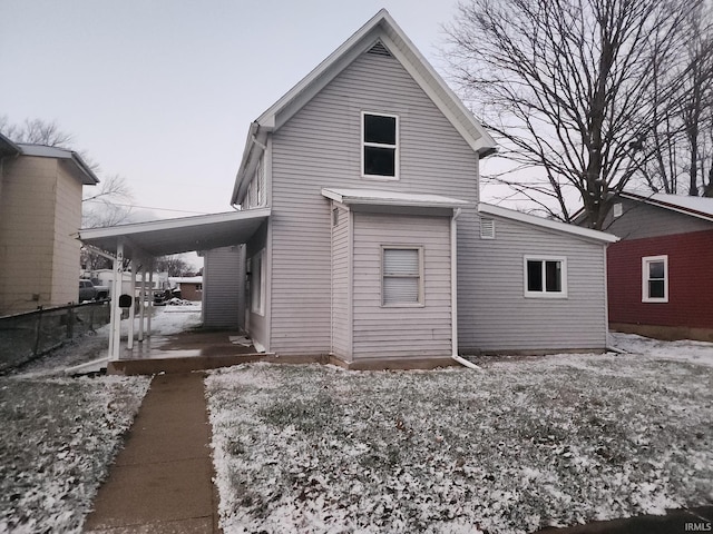 rear view of house featuring a carport