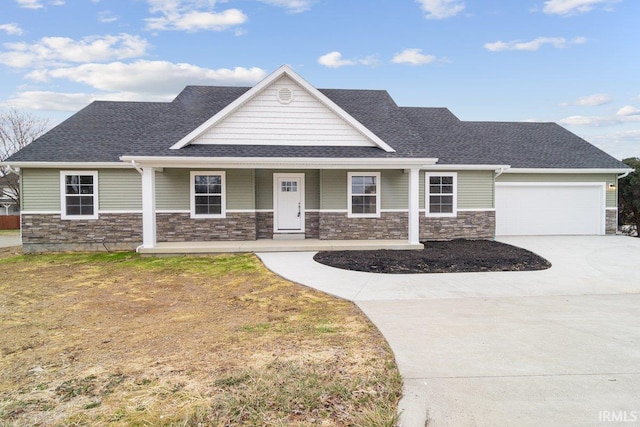 3711 Kansas Rd, Evansville, IN 47725 - view of front of house with stone siding, driveway, a garage, roof with shingles, and covered porch