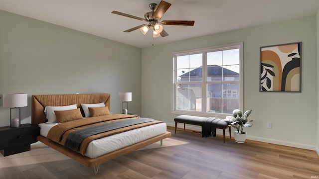 bedroom with light hardwood / wood-style flooring and ceiling fan