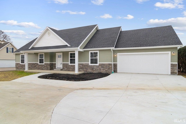 3711 Kansas Rd, Evansville, IN 47725 - craftsman inspired home with stone siding, driveway, an attached garage, a shingled roof, and covered porch