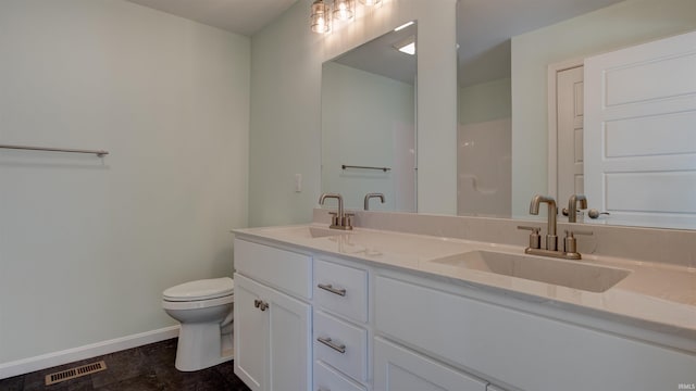 bathroom with tile patterned flooring, vanity, and toilet