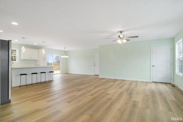 3711 Kansas Rd, Evansville, IN 47725 - unfurnished living room with a ceiling fan, light wood-style floors, and recessed lighting