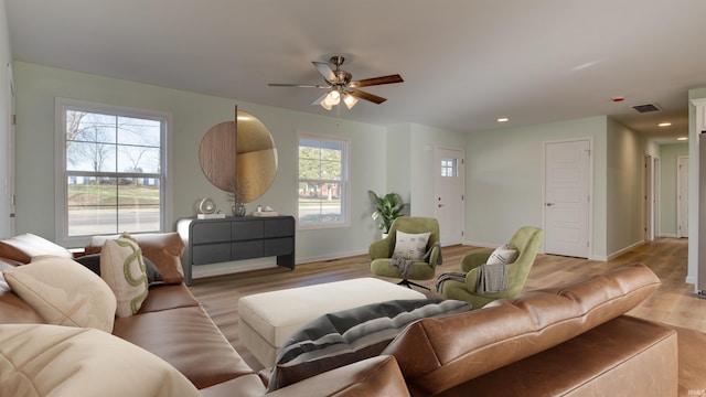 living room with ceiling fan, light hardwood / wood-style floors, and a healthy amount of sunlight