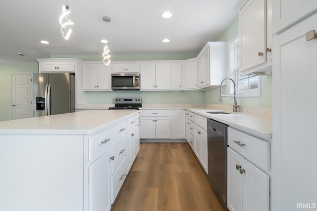 3711 Kansas Rd, Evansville, IN 47725 - kitchen with stainless steel appliances, a center island, white cabinetry, light countertops, and recessed lighting