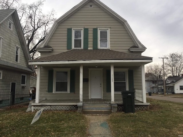 bungalow-style home with a porch and a front lawn