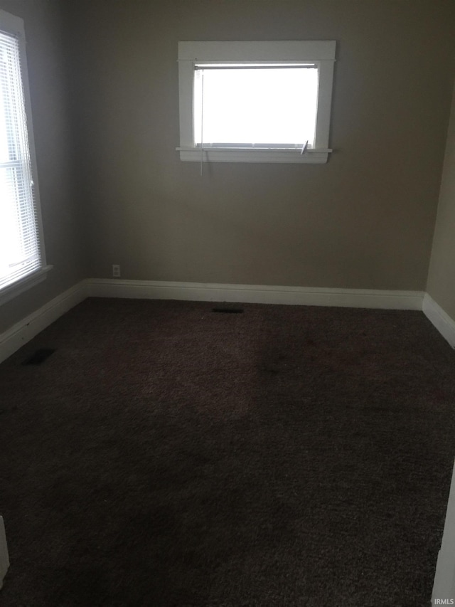 carpeted spare room with a healthy amount of sunlight