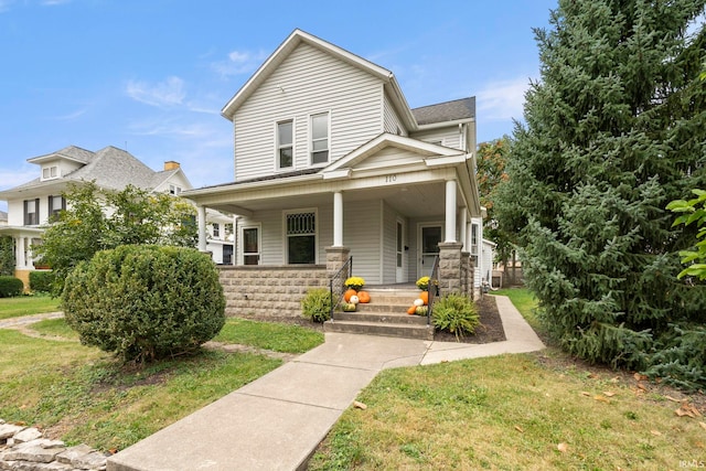 view of front of house featuring a front yard and a porch