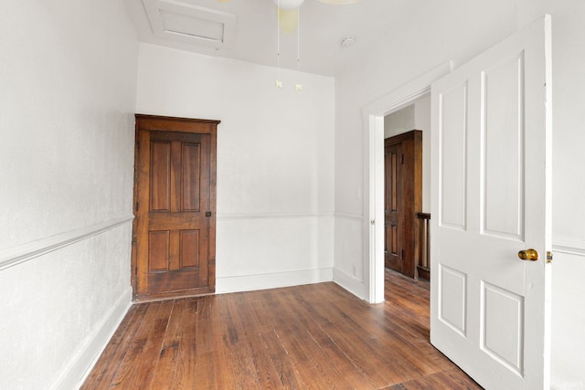 empty room with ceiling fan and dark wood-type flooring