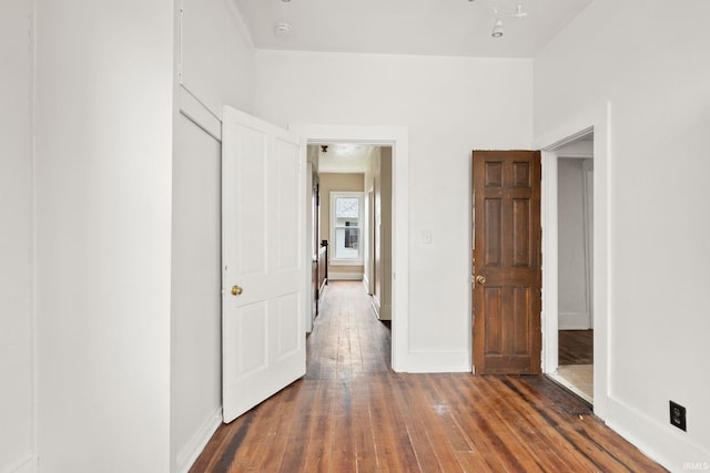 unfurnished bedroom featuring dark hardwood / wood-style flooring