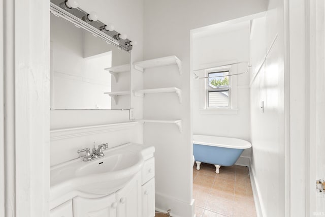 bathroom with a washtub and vanity