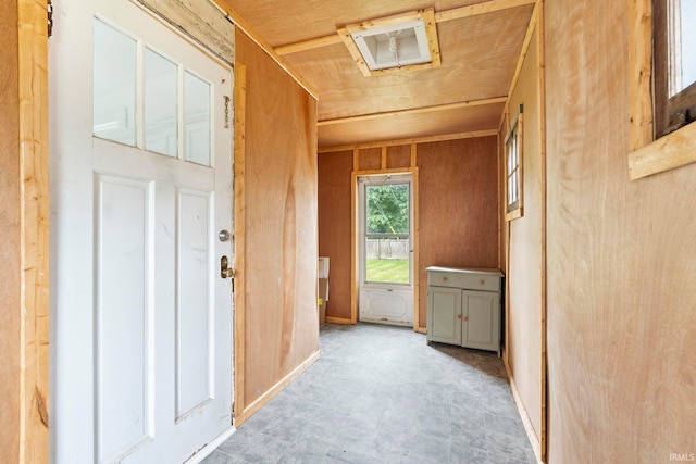 entryway with wood walls and wood ceiling