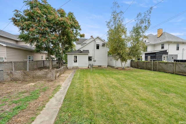 back of house with a lawn