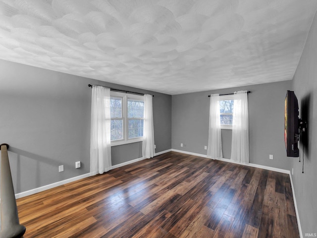 spare room featuring dark hardwood / wood-style floors