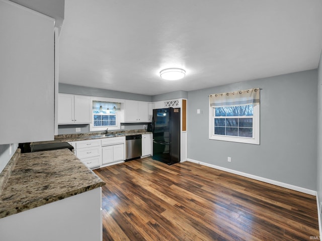 kitchen featuring dishwasher, white cabinets, black refrigerator, dark stone countertops, and dark hardwood / wood-style flooring