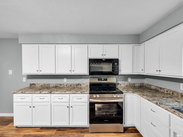 kitchen featuring stone counters, light wood-type flooring, white cabinetry, and stainless steel range