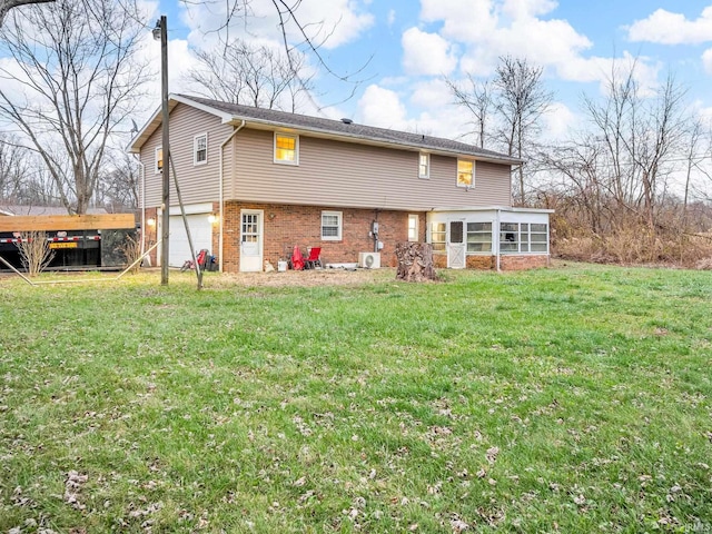 rear view of property with a lawn and a garage