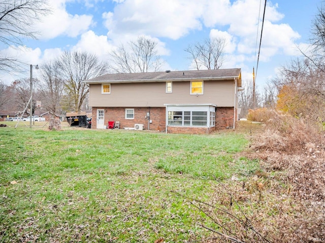 back of property featuring a lawn