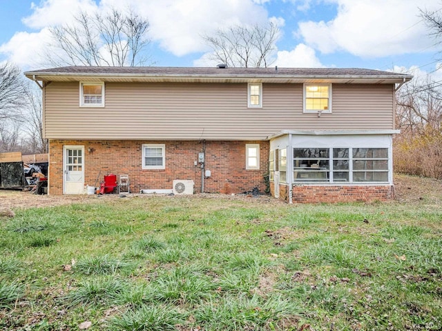 rear view of house featuring a lawn and ac unit