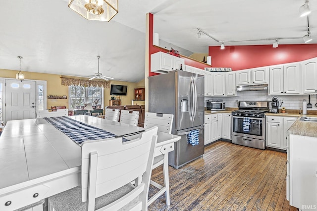 kitchen featuring appliances with stainless steel finishes, tasteful backsplash, ceiling fan, pendant lighting, and white cabinets