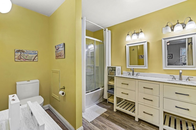 bathroom featuring vanity, bath / shower combo with glass door, and hardwood / wood-style flooring