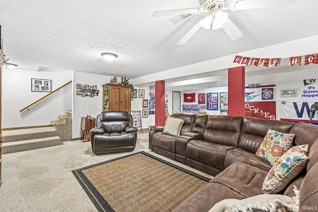 carpeted living room with ceiling fan and a textured ceiling