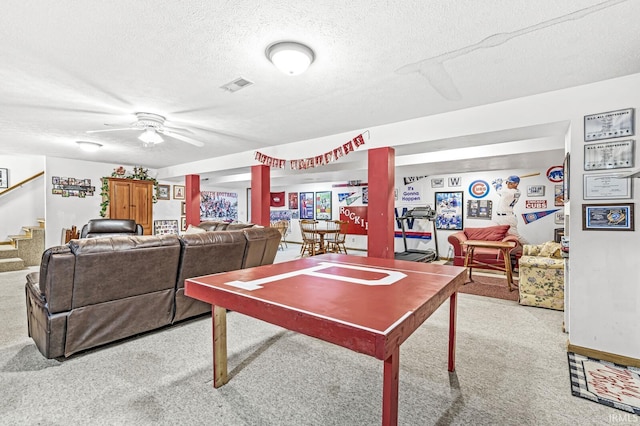 playroom with a textured ceiling, light colored carpet, and ceiling fan