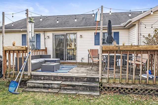 rear view of property featuring an outdoor living space and a deck