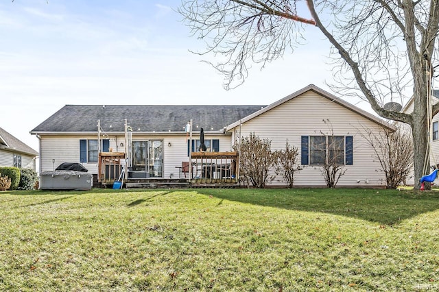 back of house with a jacuzzi, a yard, and a wooden deck