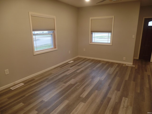 empty room with dark wood-type flooring