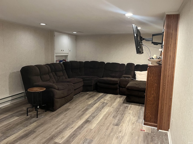 living room with wood-type flooring and baseboard heating