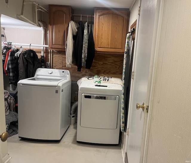 laundry room with washer and dryer and cabinets