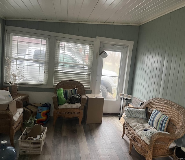 sitting room featuring hardwood / wood-style floors, wooden walls, and wooden ceiling