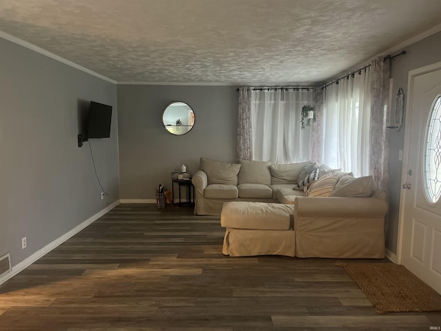 unfurnished living room featuring dark hardwood / wood-style floors, ornamental molding, and a textured ceiling