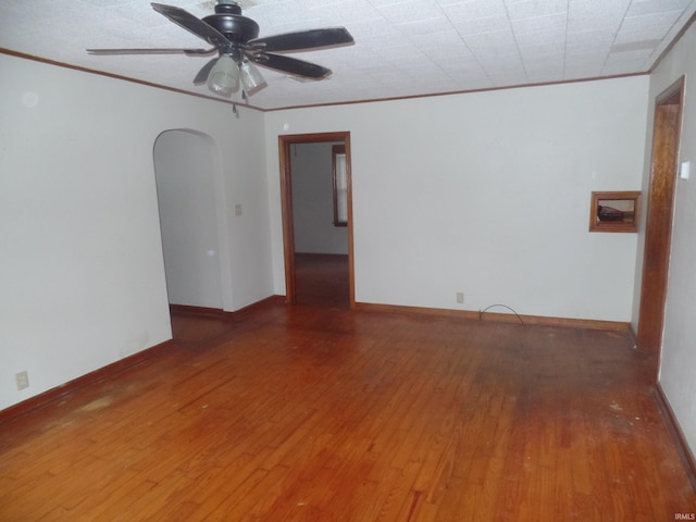 empty room with hardwood / wood-style floors, ceiling fan, and ornamental molding