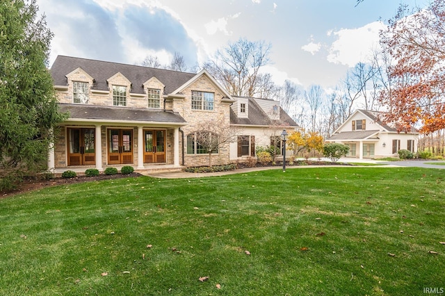 exterior space with a front yard and french doors