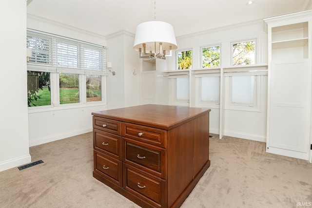 walk in closet featuring light carpet and a notable chandelier